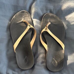 OluKai Black and gold flip flops